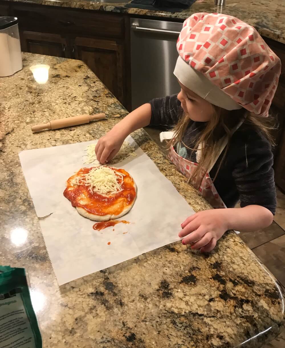 Little girl making a pizza