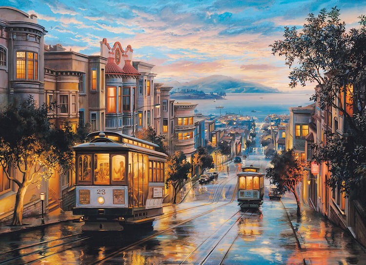A street in San Francisco with two streetcars and the bay in the background