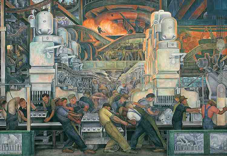 Men working on a large engine in a factory