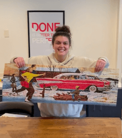 Girl lifting puzzle with ice skaters and a red car