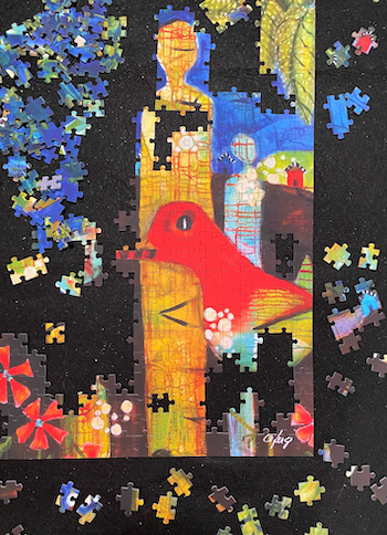A puzzle in progress with a red bird in the middle
