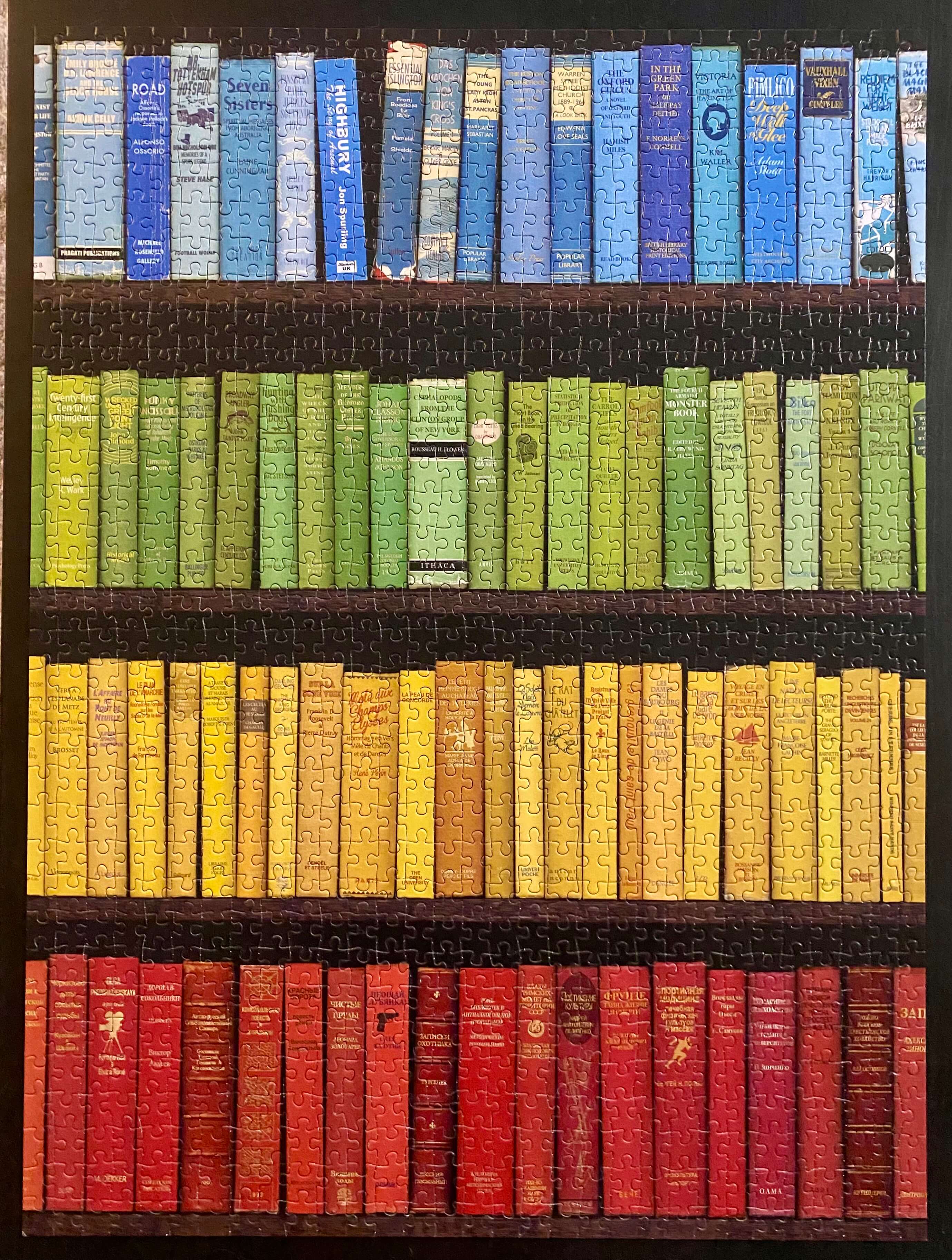 Puzzle of Books by Color on Bookshelf