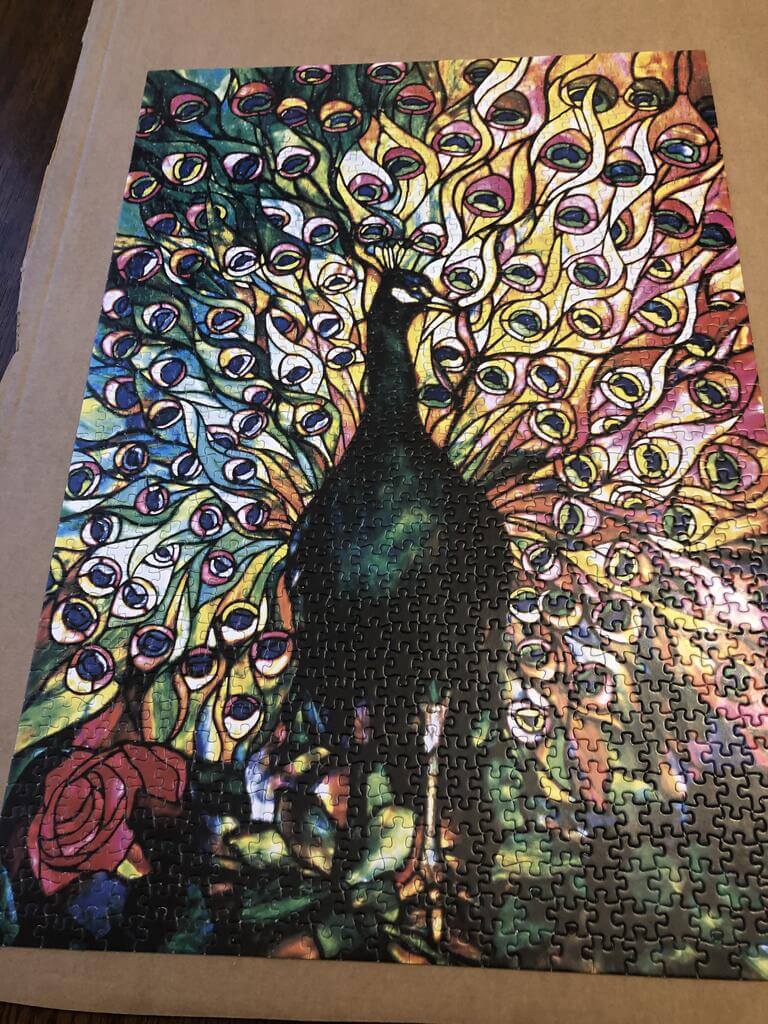 A puzzle of a peacock in a stained glass tyle