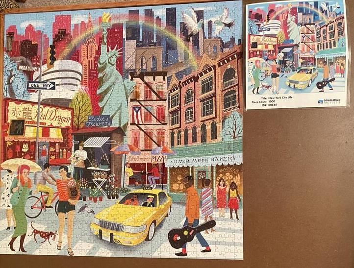 Puzzle of New York City street with Statue of Liberty and Rainbow at top