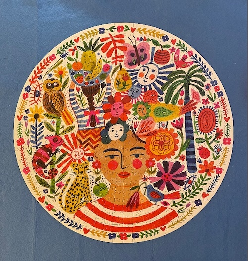 Most challenging puzzles for adults: Round puzzle of a woman with animals and smiling faces and flowers.