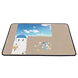 Puzzle Board with half finished puzzle of white building and blue roof and sky