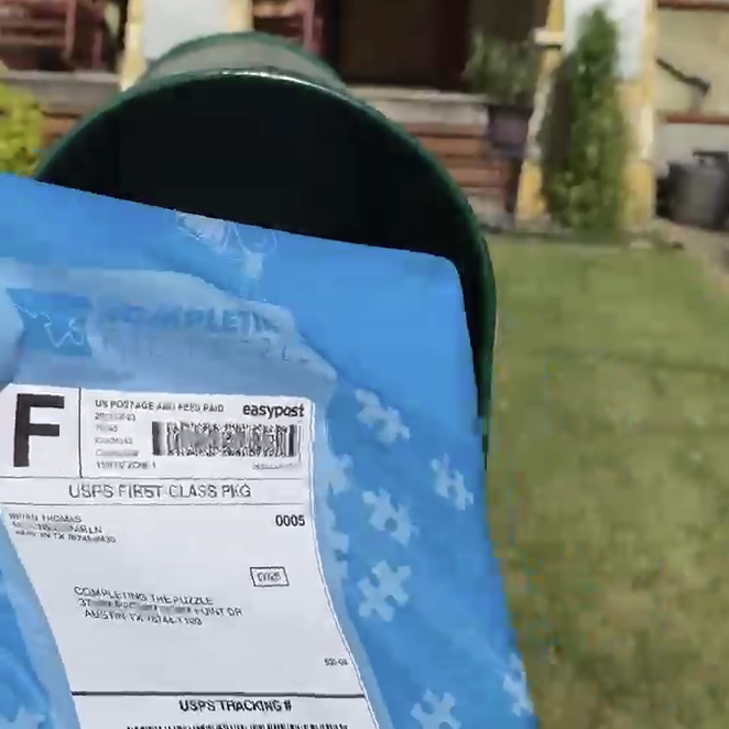 Puzzle mailer being placed in mailbox